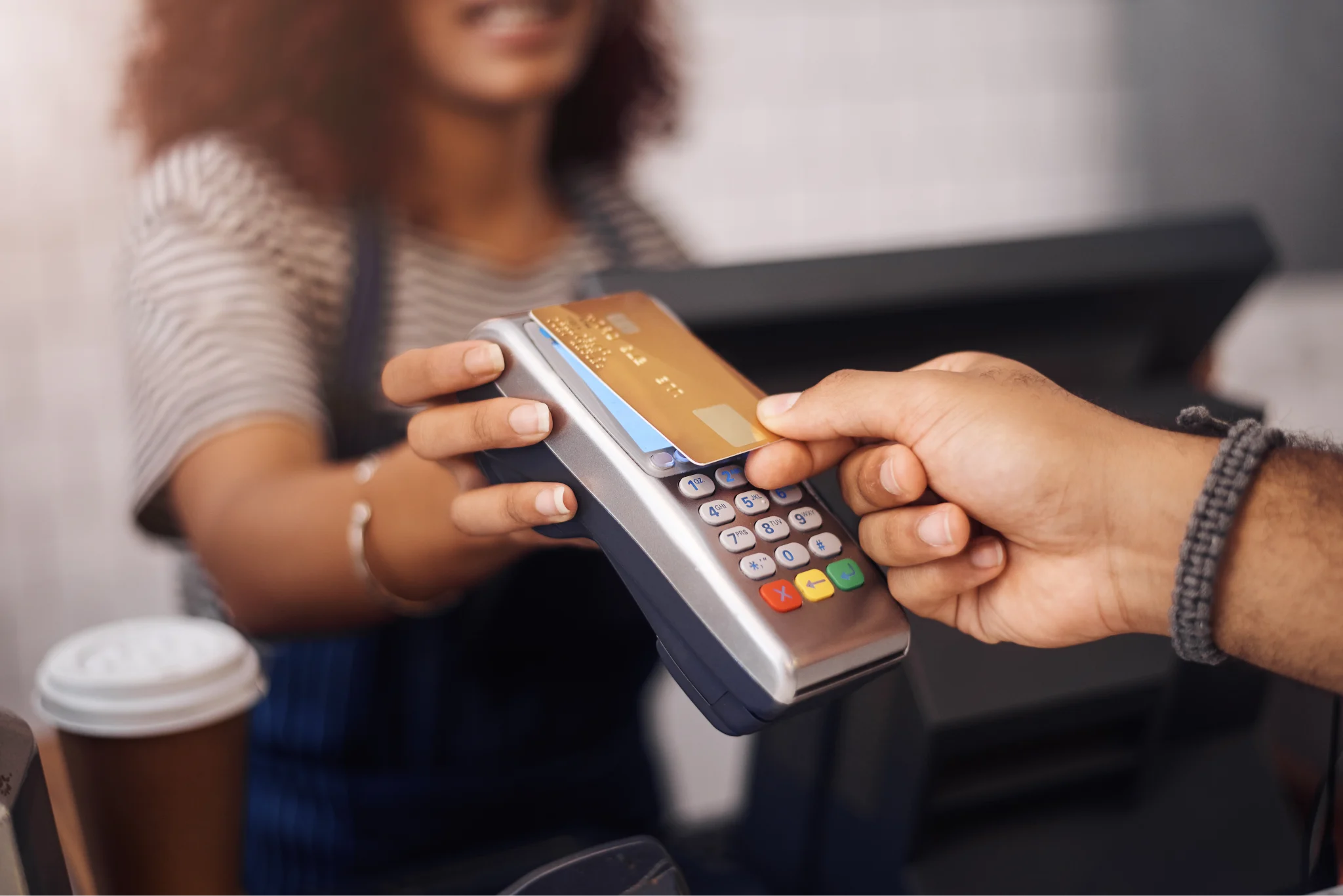 An illustration of a credit card sliding through a point of sale system